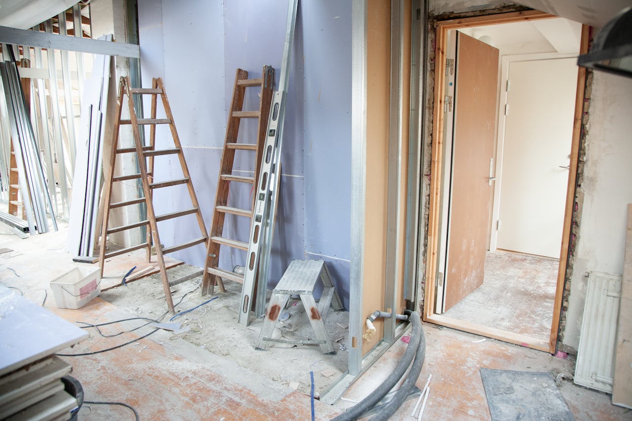 about-us Construction site featuring ladders and tools in a home renovation setting.